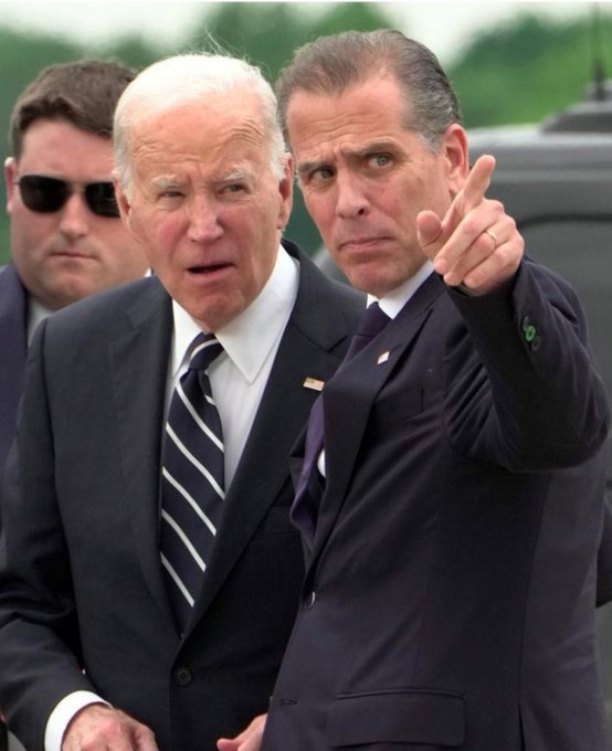 Joe Biden and his son Hunter appear concerned as they walk together, with Hunter pointing ahead. The image relates to the post mocking Hunter Biden's failed cryptocurrency launch, showing the pair looking worried—aptly reflecting the dramatic 99.11% crash of his "$LAPTOP" token within 90 minutes.