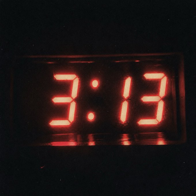 A digital alarm clock glows red in the dark, displaying the time 3:13 in bright segmented numerals. The early morning hour complements the "WEN CETPFP" caption, referencing the well-known PARMYS voice memo about waking up at 3:13 a.m.