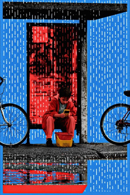 The image features a young boy sitting on a bench with his legs crossed, looking down at his cell phone. The scene takes place outdoors during rainy weather, as evidenced by the puddles around him. There are two bicycles parked nearby - one closer to the left side of the image and another further back towards the right side. A watermark in the bottom right corner reads "day 200".