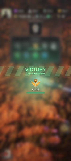 A blurry mobile game screenshot showing a 'VICTORY' banner with '+24 Rank Points' and a 'Gold II' achievement icon.