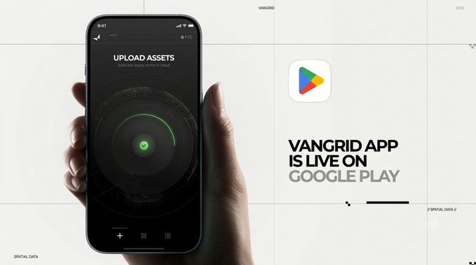 A promotional image for 'VANGRID APP IS LIVE ON GOOGLE PLAY', showing a hand holding a smartphone displaying an 'UPLOAD ASSETS' screen with a green loading circle.