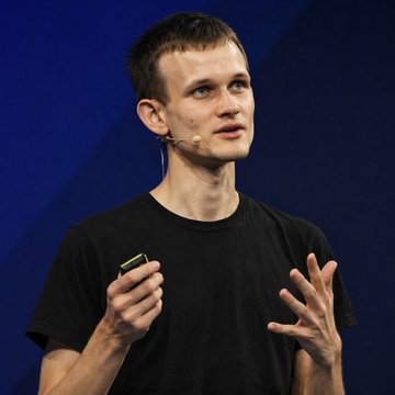 Vitalik Buterin speaks on stage while holding a presentation clicker, illustrating the post about his vision for Ethereum's future priorities, including quantum safety, privacy, censorship resistance, and simplicity.