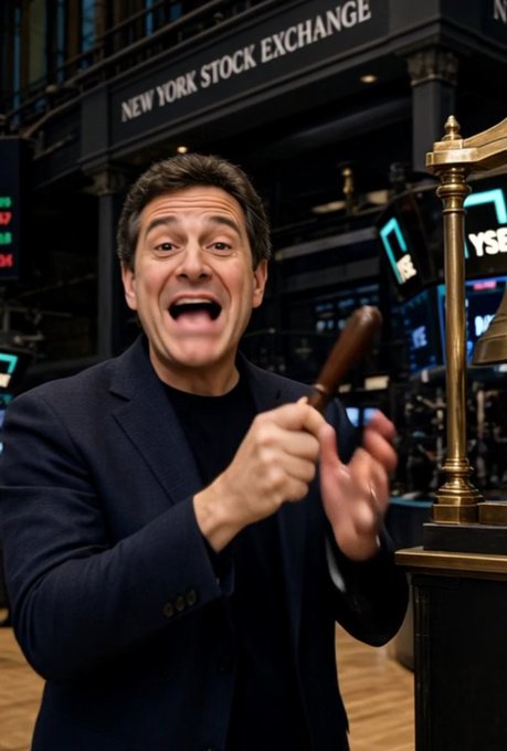 A man in a dark suit excitedly shouts while ringing a brass bell at the New York Stock Exchange, with 'NEW YORK STOCK EXCHANGE' visible on a sign in the background.