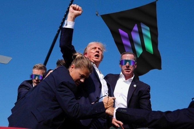 The image shows a group of people wearing sunglasses, with one person holding up a flag that has "SOLANA will win" written on it. The flag appears to be black and purple, and the text "SOLANA will win" is prominently displayed in white letters against the black background. The people are standing close together, suggesting they might be attending an event or gathering related to the flag's message.
