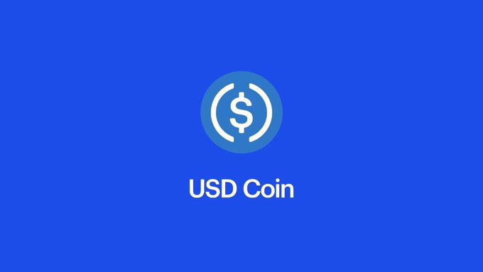 A blue screen displaying the white USD Coin (USDC) logo with the text 'USD Coin' centered below it.