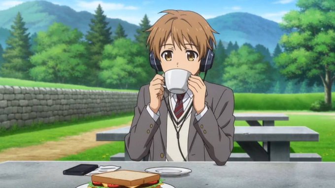 A young male anime character with light brown hair and headphones sips from a white cup at a picnic table, with a sandwich and sandwich-making ingredients laid out before him. The image evokes the "gm" (good morning) crypto greeting, showing someone casually enjoying a morning moment in a lush outdoor setting while tuning into the "onchain" world through their headphones.