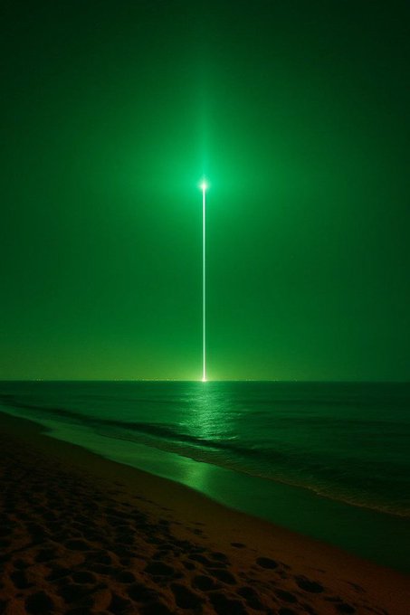 A nighttime beach scene with a bright green laser beam shooting vertically into the sky from the ocean horizon.