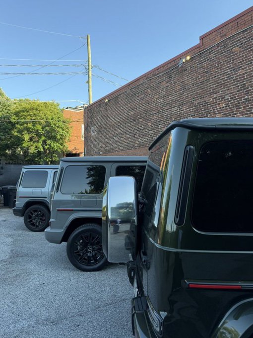 The image features three GM CT The @FIH_USD1 cars parked next to each other in a parking lot. The cars are of different colors - silver, black, and green. They appear to be parked at an angle, with one car positioned more towards the left side of the frame and two others on the right side. The cars seem to be well-maintained and ready for use.