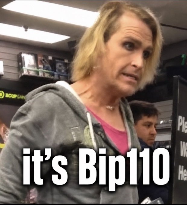 A confused-looking woman with a concerned expression stands in what appears to be a computer store, with text overlay reading "It's BIP110" — used as a meme to mock Bitcoin Improvement Proposal 110 by comparing BIP110 supporters' insistence on being called "Bitcoin" to preferred pronoun usage and the woman's apparent bewilderment.