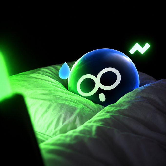 A glossy black sphere with an infinity symbol and a blue sweat drop rests on green-lit fabric, with a green zigzag line above it. The image, paired with a "Loading..." caption, playfully illustrates the anxiety of waiting indefinitely for something to finish.