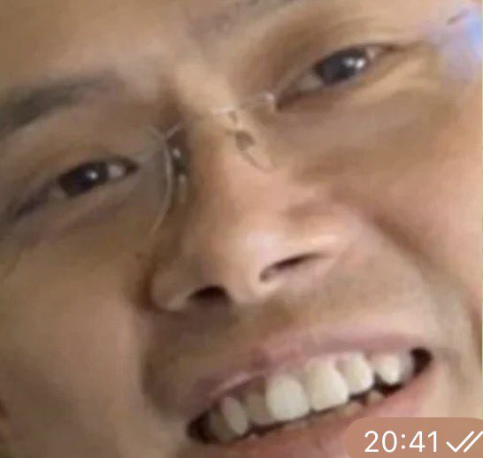 A close-up selfie shows a man wearing glasses smiling at the camera, with a timestamp of "20:41 ✓✓" visible in the bottom right corner, suggesting a WhatsApp screenshot capturing his hopeful anticipation as he waits for "CZ" (likely referring to Changpeng Zhao of Binance). The accompanying caption about patience and waiting for a miracle aligns with the man's warm, optimistic smile and double-checkmark timestamp indicating a sent message.