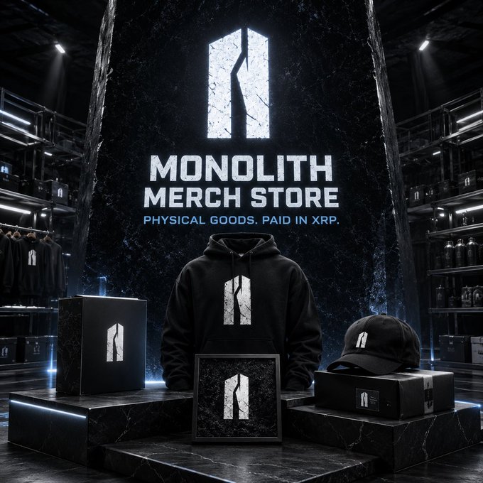 A promotional graphic for 'MONOLITH MERCH STORE' featuring a cracked logo, with text stating 'PHYSICAL GOODS. PAID IN XRP.' displayed above a black hoodie, cap, and framed art on display pedestals.