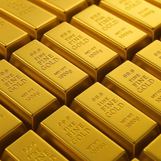 A stack of gold bars stamped "99.9 FINE GOLD NET WT 1000g" is neatly arranged in rows, visually representing the precious metal whose price correlation with Bitcoin has surged to a near six-year high, as reported by Bitwise.