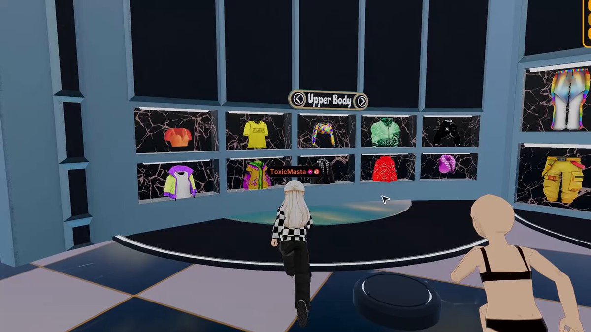 The image shows two people standing inside of a virtual clothing store with a large window displaying various outfits. One person appears to be wearing a black shirt, while the other has a white shirt on. They are both looking at the clothes displayed in front of them, possibly deciding what to try on or purchase. The post suggests that they should focus on one outfit and prove their worth by strutting down the runway together.