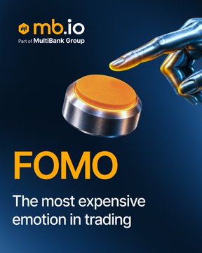 An MB.io (MultiBank Group) promotional graphic features a robotic finger pressing an orange button with the text 'FOMO: The most expensive emotion in trading.'