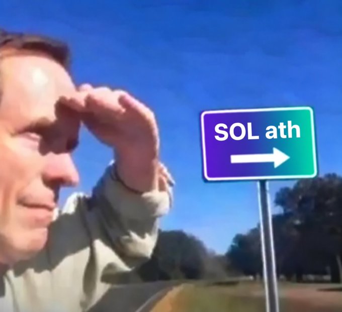 A meme image of a man shading his eyes while looking ahead, next to a road sign that reads "SOL ath" with an arrow pointing right, referencing Solana reaching an all-time high.