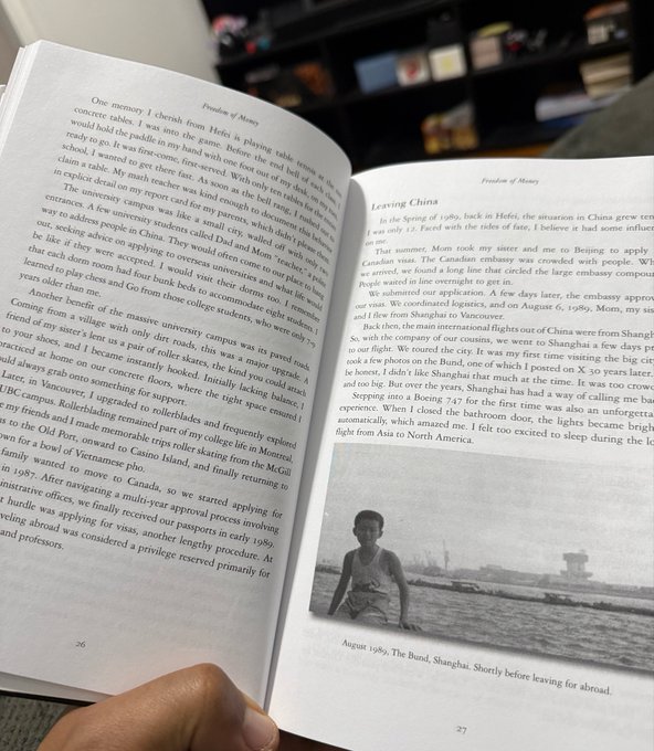 A person holds open a book showing page 26-27 with a chapter titled "Freedom of Money" and a subsection "Leaving China," featuring a black-and-white photo captioned "August 1989, The Bund, Shanghai." The visible text describes the author's childhood and parents' struggles in China, aligning with the post's reference to CZ's father and early hardships.