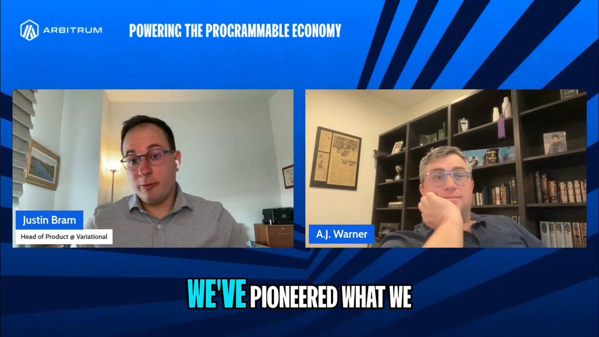 The image shows two men sitting at a desk with their hands resting on their laps while they are talking to each other, possibly discussing business or sharing ideas. The background of the image features a blue banner that reads "We've Pioneered What We Do" along with some text about the importance of infrastructure in the programmable economy and how it has been applied to the Arbitrum platform by @ Justin CBram and the @variational_io team.