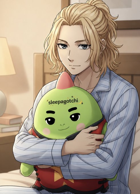 Anime-style illustration of a blonde male character in striped pajamas hugging a green 'sleepagotchi' plush toy on a bed.