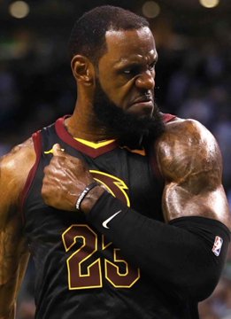 LeBron James, wearing his #23 Cleveland Cavaliers jersey, clenches his fists with an intense, focused expression in this close-up shot. The image visually connects to news of rising odds for his return to Cleveland, showing the star in his iconic Cavaliers uniform.