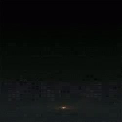 The image shows a dark sky with a bright light at the center, possibly an explosion or firework display. The focus of the image is on this central point, drawing attention to its brightness against the darkness surrounding it. The caption below the image provides context about the content and the creator's intention behind sharing the photo.