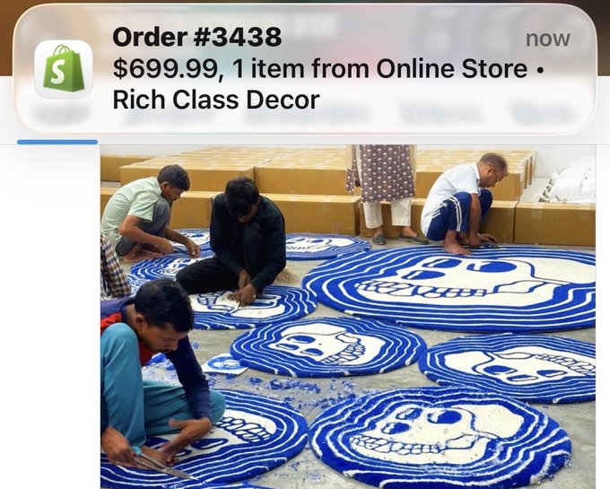 A screenshot of a mobile order notification from Shopify reading 'Order #3438, $699.99, 1 item from Online Store • Rich Class Decor', displayed above a photo of several men working on intricate blue and white skull-shaped bead mosaics on the floor.