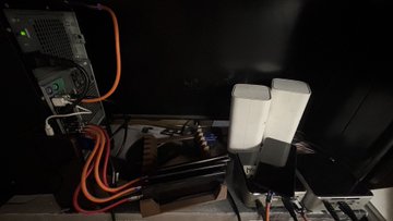 A homemade rocket launch pad setup with two white PVC launch tubes mounted on a base, connected via colorful tubing to a control computer, likely being used to celebrate the community member's "AROversary" milestone. The setup appears to be a DIY rocket test stand shared as a tribute to a longtime contributor in the rocketry community.