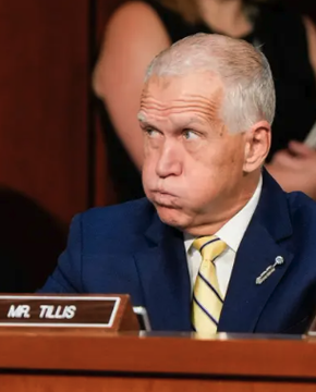 Sen. Thom Tillis, identified by the "MR. TILLIS" nameplate visible in the image, listens during a Senate hearing as he publicly warns that the CLARITY Act is "likely to fail" next week due to stalled ethics negotiations involving Trump and his family.