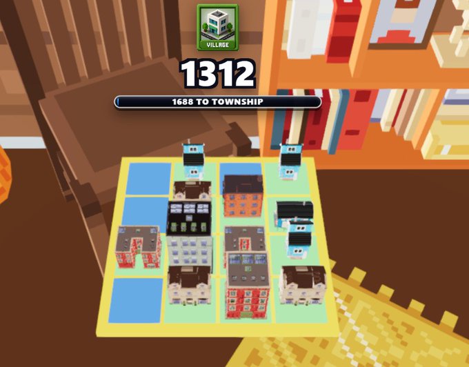 A screenshot of a pixel-art city building game showing a 4x4 grid on a yellow board with various buildings like houses, skyscrapers, and a school, with a score of '1312' and text '1688 TO TOWNSHIP' at the top.