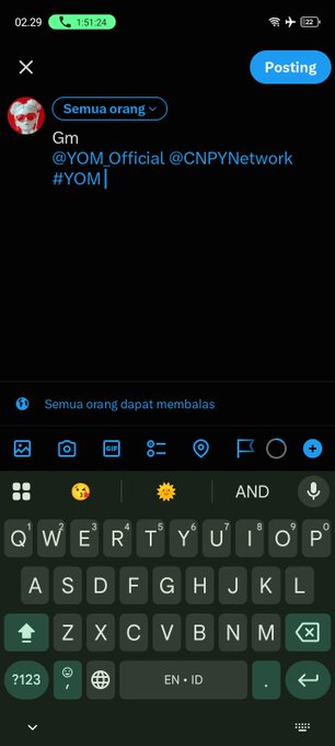 A screenshot of a mobile phone showing a social media post being composed with the text 'Gm @YOM_Official @CNPYNetwork #YOM' above a keyboard.