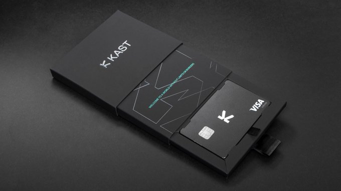 A sleek black card slides out of a matte black box branded with the "KAST" logo, accompanied by a Visa-branded card, visually reinforcing the post's message that KAST is a tangible, real-world financial product—not just another speculative Web3 token project.