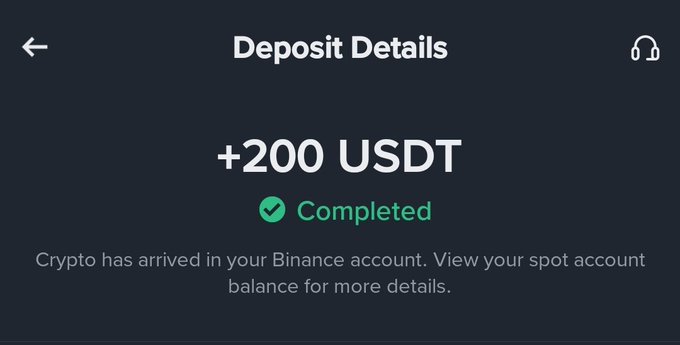 A dark-themed Binance app screenshot showing a completed deposit of '+200 USDT' with text 'Crypto has arrived in your Binance account. View your spot account balance for more details.'