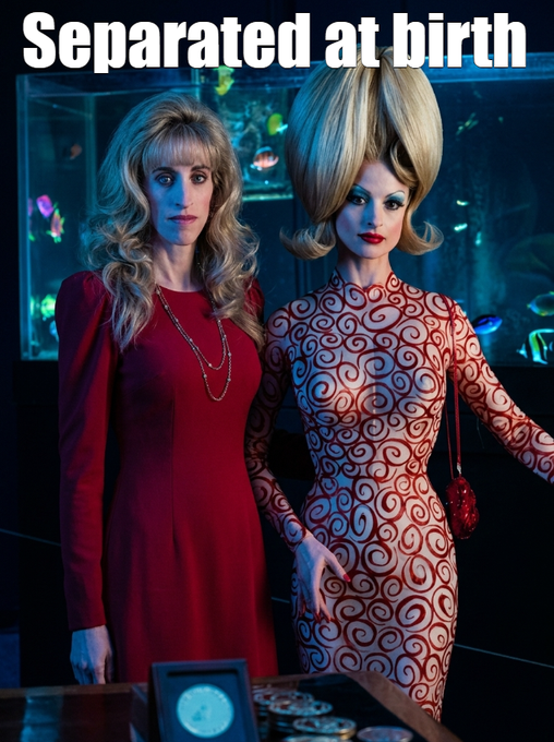 Two blonde women stand side-by-side in front of an aquarium with the caption "Separated at birth," one in a solid red dress and pearls, the other in a patterned red dress with bold, beehive hair.