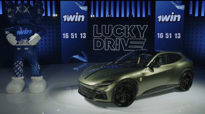 A sleek, matte olive-green Ferrari Purosangue is displayed on a stage under "LUCKY DRIVE" signage, flanked by "1win" promotional banners and a large blue 1win mascot character. The image directly illustrates the post's mention of a $400K car prize giveaway by 1winPro, showing the luxury vehicle centerpiece alongside the brand's promotional setup.