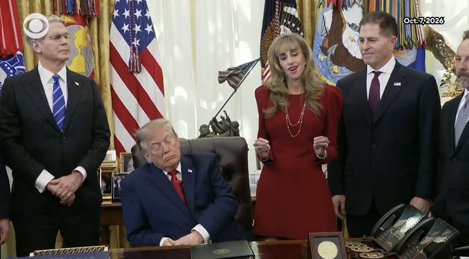 A scene dated Oct. 7, 2026 in the Oval Office showing Donald Trump seated at his desk surrounded by officials including a woman in a red dress, with American flags in the background.