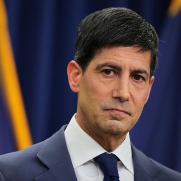 The image shows a close-up portrait of Kevin Warsh, identified in the accompanying post as the Federal Reserve Chair, dressed in a dark suit and tie, appearing serious at what looks like an official press event. The photo relates to the news about his upcoming Fed decision, which is expected to influence Treasury yields and broader financial markets including Bitcoin and risk assets.