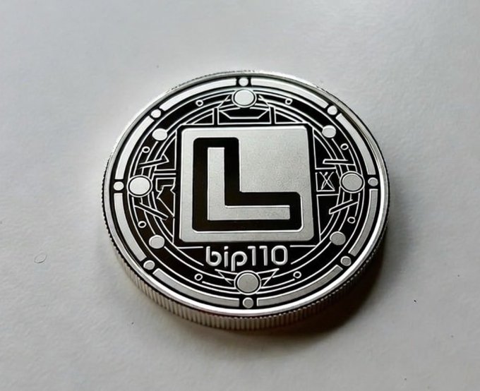 A close-up of a silver coin engraved with "bip110" beneath a stylized "L" emblem within a circuit-like border, representing the satirical "Luke Coin" referenced as a real-world parody of what Bitcoin might look like had BIP-110 passed.