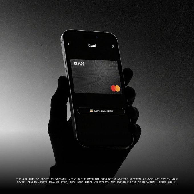 A silhouetted hand holds an iPhone displaying the OKX Card screen with an "Add to Apple Wallet" button, promoting the crypto debit card's new European perks including €20 cashback and subscription discounts. The image directly visualizes the announcement of OKX Card's enhanced rewards and zero-fee features for European users.