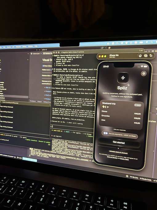 A photograph of a MacBook laptop displaying a code editor (Cursor) with a preview window open, showing an iPhone mockup of a financial app called 'Spiz' with a list of weekend trip expenses.