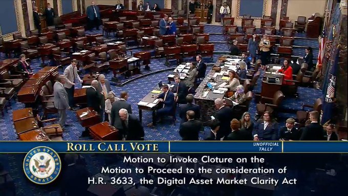 The image shows the U.S. Senate chamber during a roll call vote, as indicated by the on-screen graphic reading "ROLL CALL VOTE" with the "Unofficial Tally" label, regarding the "Motion to Invoke Cloture on the Motion to Proceed to the consideration of H.R. 3633, the Digital Asset Market Clarity Act." This visually confirms the post's claim that voting on the Clarity Act has officially begun, as senators are gathered around desks in the chamber for the procedural cloture vote on the digital asset legislation.
