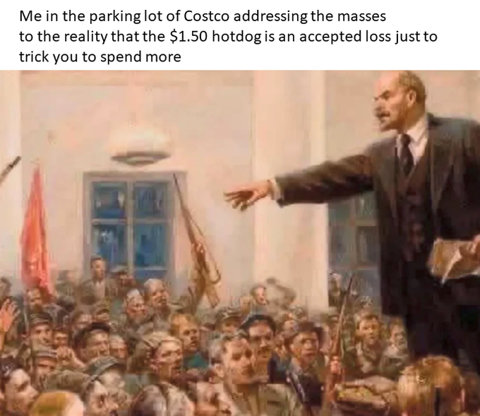 The image shows a crowd of people gathered together with a man standing at the front of them, giving a speech or lecture. The scene appears to be set in an art gallery or museum, as there are several paintings displayed around the room. The painting that stands out is a depiction of a man holding a gun and pointing it towards a group of people. This artwork seems to be a commentary on the current state of Bitcoin and its rapid growth.