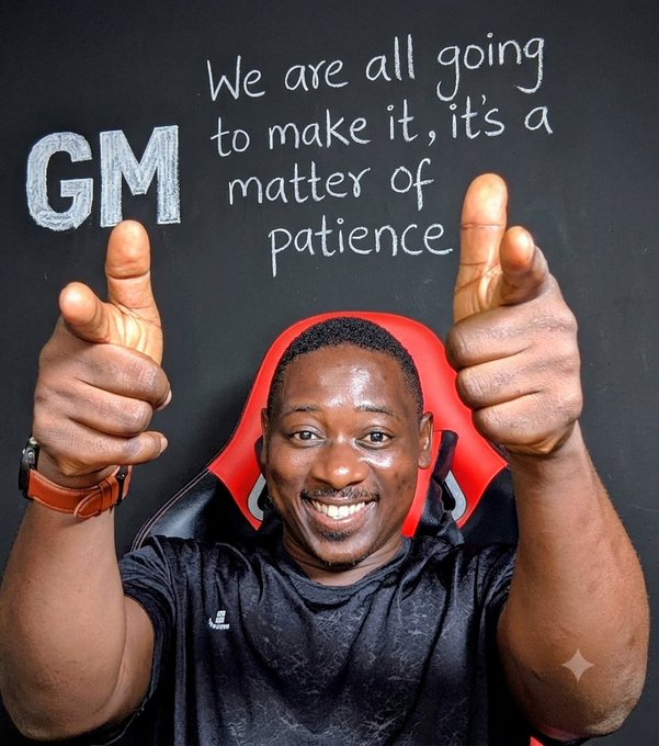 A smiling man gives a double thumbs-up in front of a chalkboard displaying "GM" and the message "We are all going to make it, it's a matter of patience," visually reinforcing the post's motivational message about perseverance and an upcoming big win.