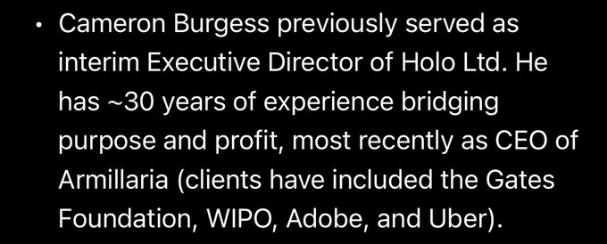 A black slide with white text stating: 'Cameron Burgess previously served as interim Executive Director of Holo Ltd. He has ~30 years of experience bridging purpose and profit, most recently as CEO of Armillaria (clients have included the Gates Foundation, WIPO, Adobe, and Uber).'