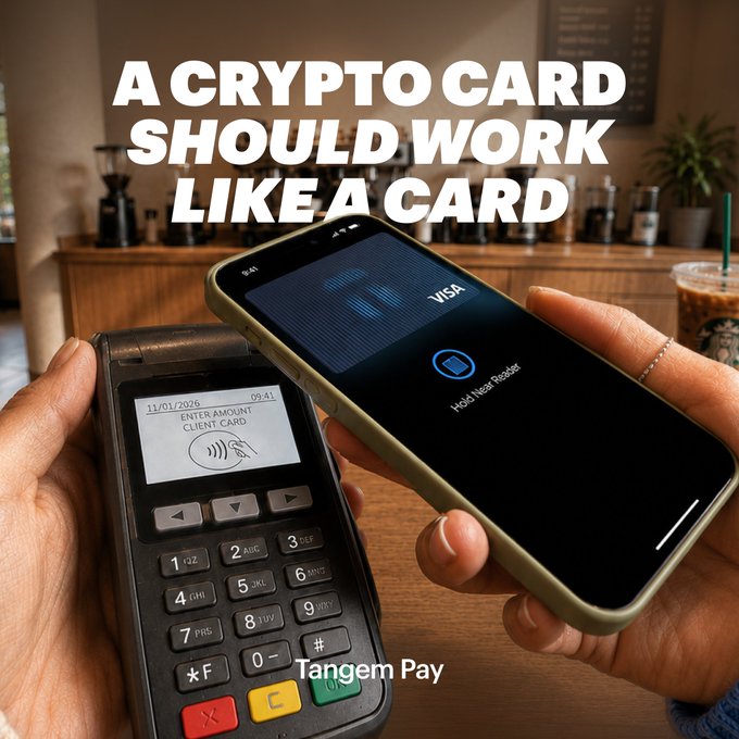 The image shows two cell phones being held by people at a table with a coffee shop setting. One of the individuals is holding a credit card reader that appears to be a crypto card, while the other person has their phone displaying a credit card transaction on its screen. The text in the image reads "A crypto card should work like a card When we launched Tangem Pay, we started with what matters most: a card that'S truly yours. Settled onchain. Now we're rolling out the card management experience to match."