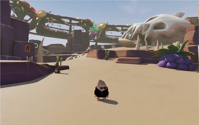 A small black and white penguin-like character standing on a sandy path in a desert-like video game environment with strange rock formations and a giant skull in the background.