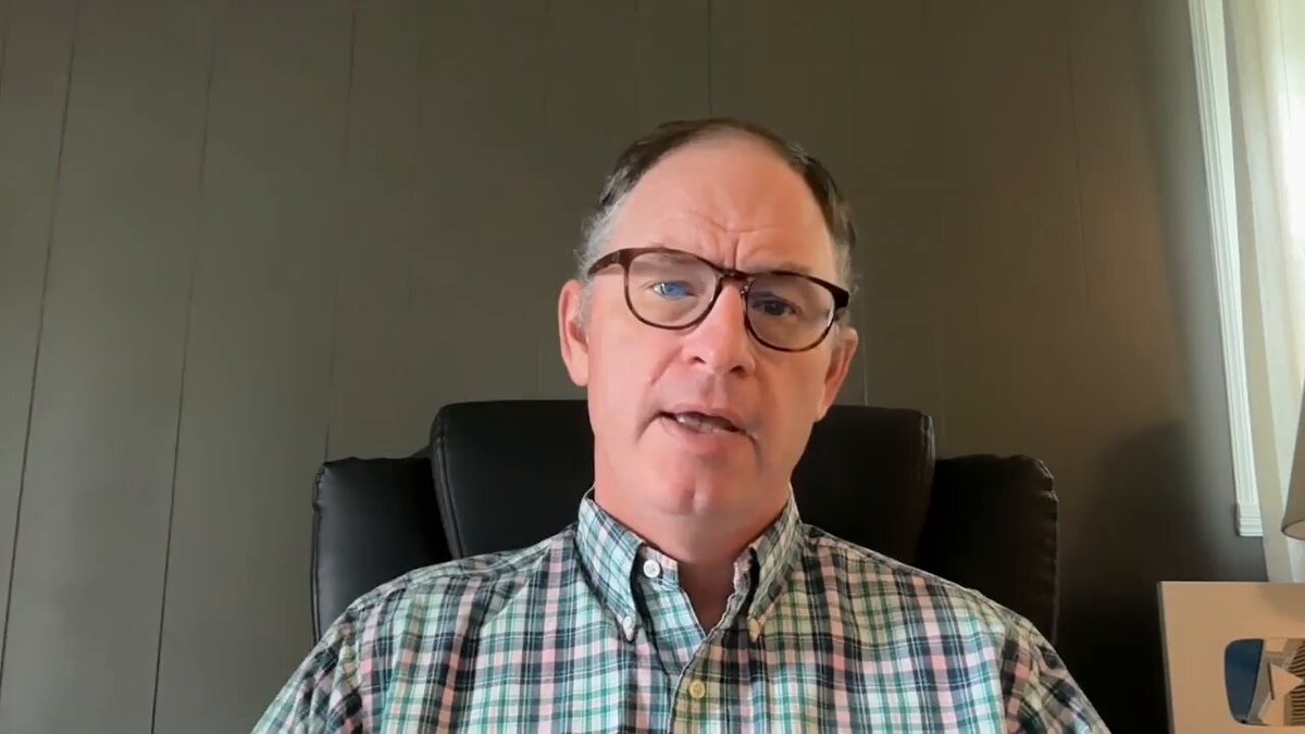 The image shows a man wearing glasses sitting in an office chair, looking at the camera with a serious expression. There are no other people or objects visible in the frame. The caption of the image reads "What The Value Of XRP Needs To Be. WOW! Watch The Full Youtube Video Here: youtu.be/71VZFWH_Eoc". This text is related to the post, as it appears that the man's serious expression and the caption are part of a video or presentation about Bitcoin or cryptocurrency.
