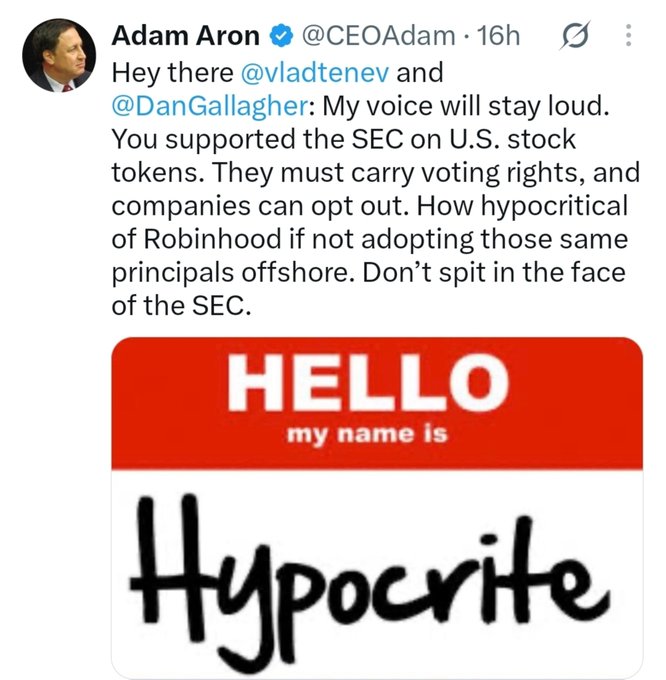 A tweet by Adam Aron (@CEOAdam) criticizing Robinhood, calling them hypocritical regarding SEC principles on U.S. stock tokens, accompanied by a "HELLO my name is Hypocrite" name tag image.