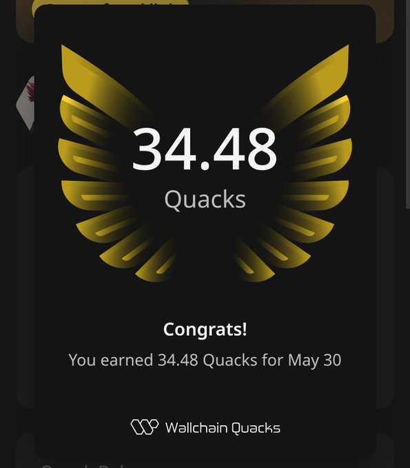 The image shows a small card with a logo, displaying a golden bird head surrounded by text in white. The text reads "Congratulations! You earned 34.48 Quacks for May 30." This indicates that the user has successfully completed an activity or task that resulted in them earning 34.48 Quacks as a reward.