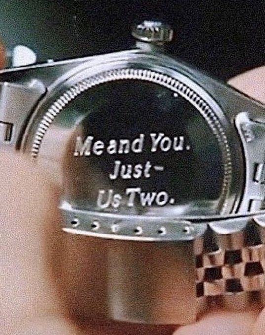 A close-up of a watch face displays the engraved message "Me and You. Just- Us Two."