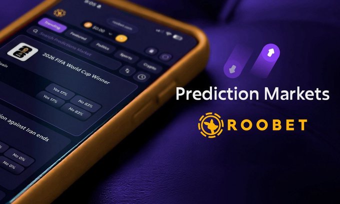 A promotional image for Roobet Prediction Markets, showing a mobile phone displaying betting odds on the 2026 FIFA World Cup Winner.